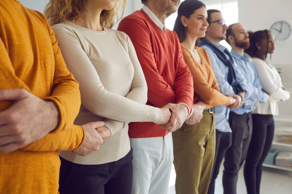 Creative interracial business team meeting hand together in line stand in office